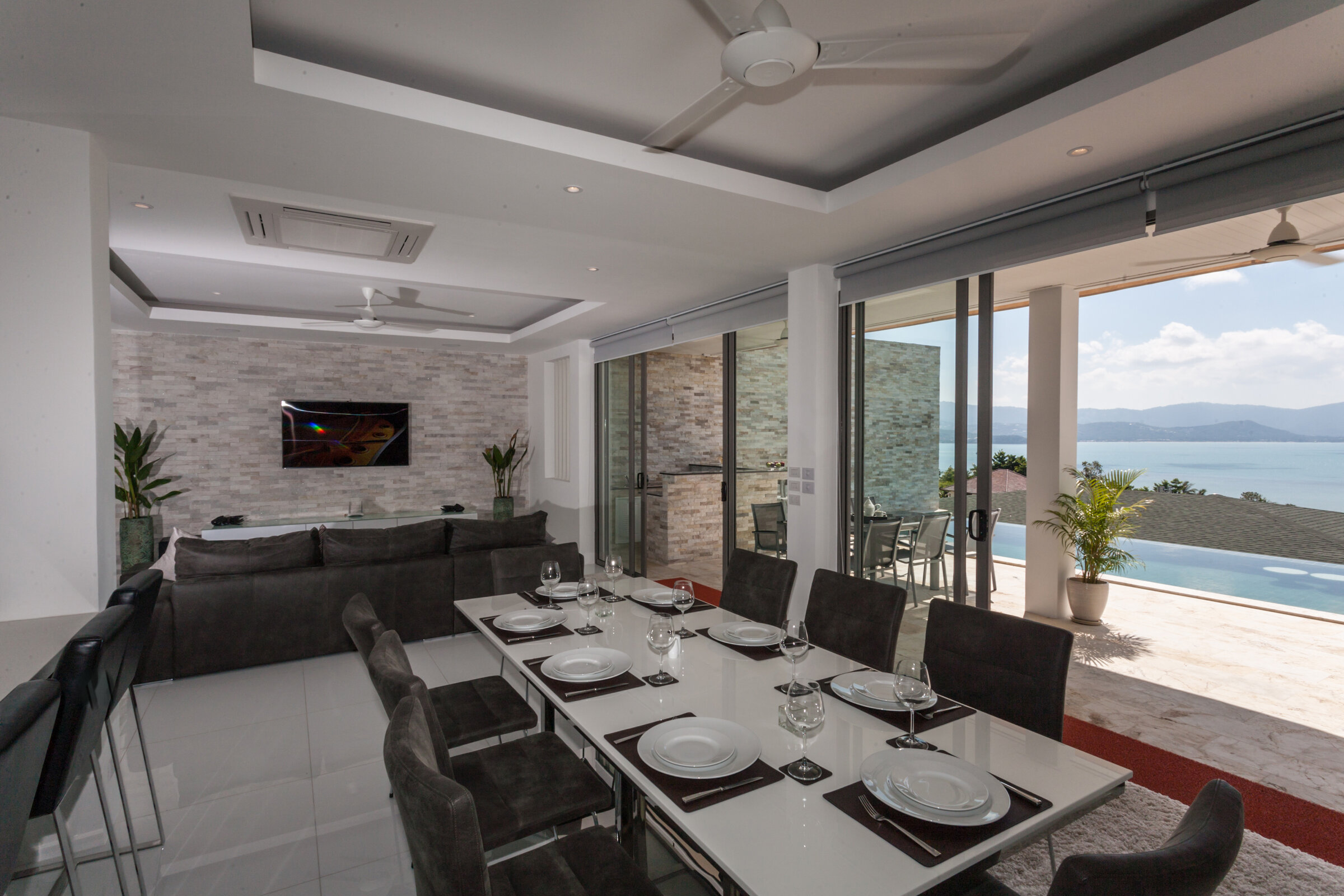 Villa Daizo living room with entertainment system and stone feature wall